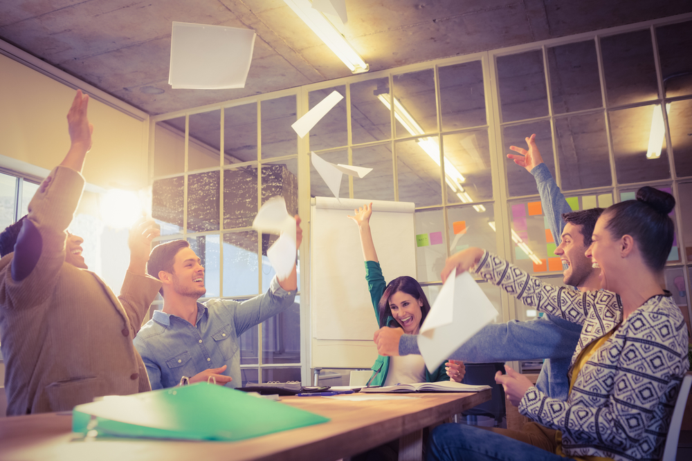 Group of business people celebrating by throwing their business papers in the air-1 Group of business people celebrating by throwing their business papers in the air-1